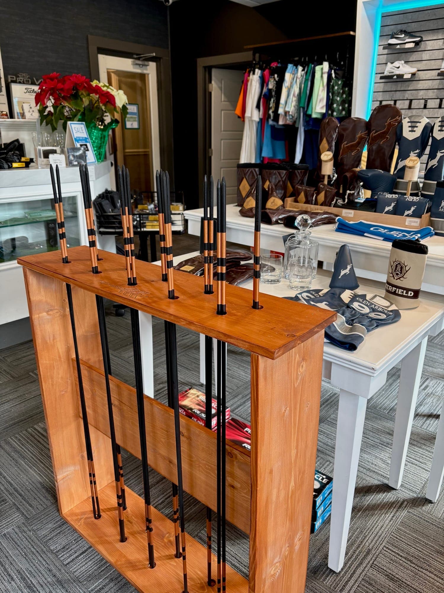 Twin Arrows Golf alignment sticks displayed in a golf shop.